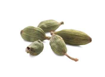 Photo of Pile of dry green cardamom pods on white background