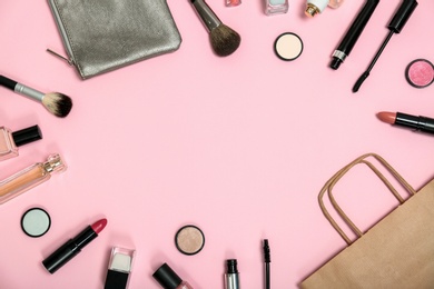 Photo of Flat lay composition with shopping bag and cosmetics on color background