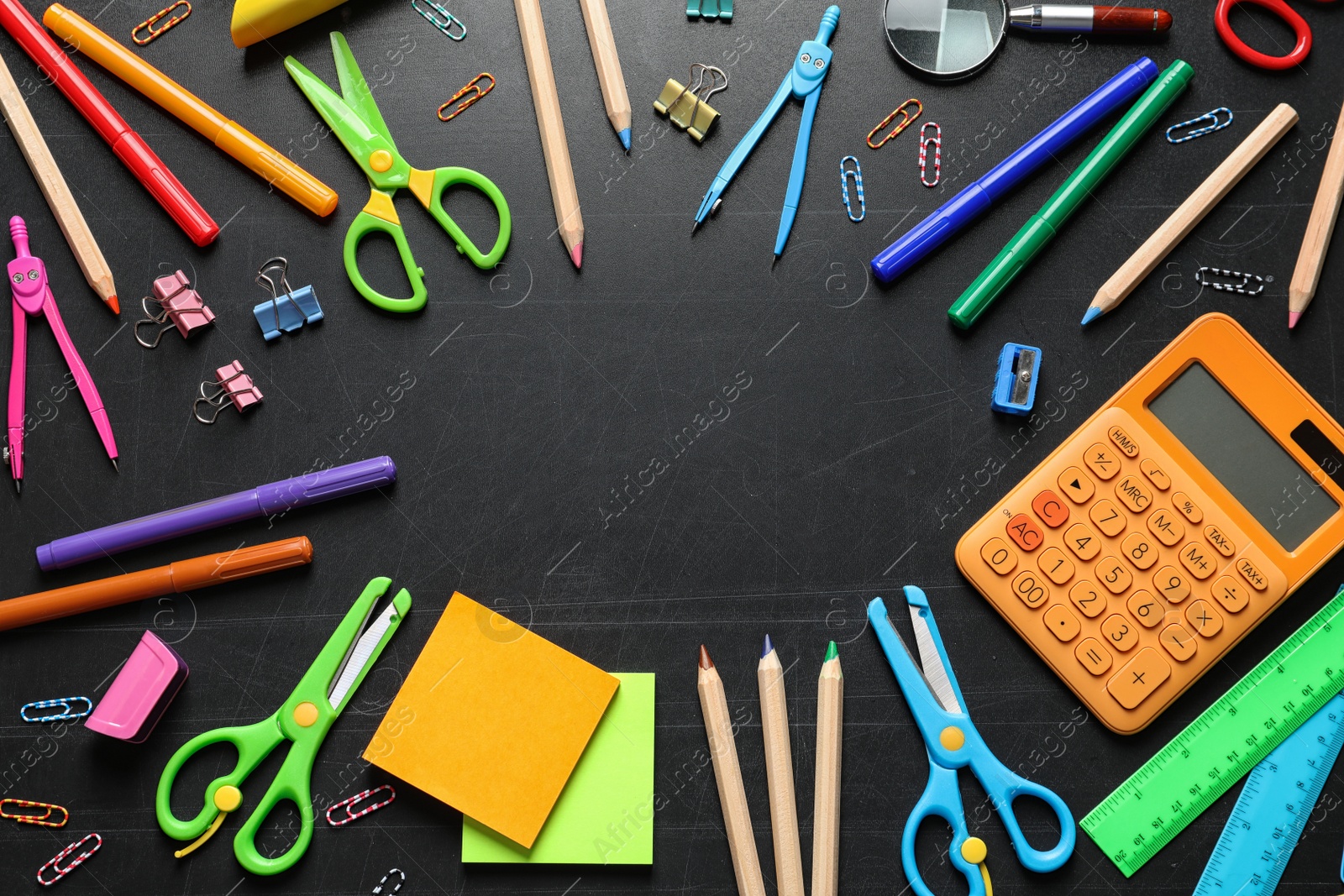 Photo of Flat lay composition with scissors and school supplies on dark background. Space for text