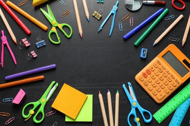 Photo of Flat lay composition with scissors and school supplies on dark background. Space for text