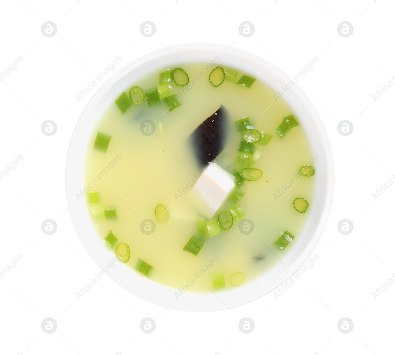 Photo of Bowl of delicious miso soup with tofu isolated on white, top view