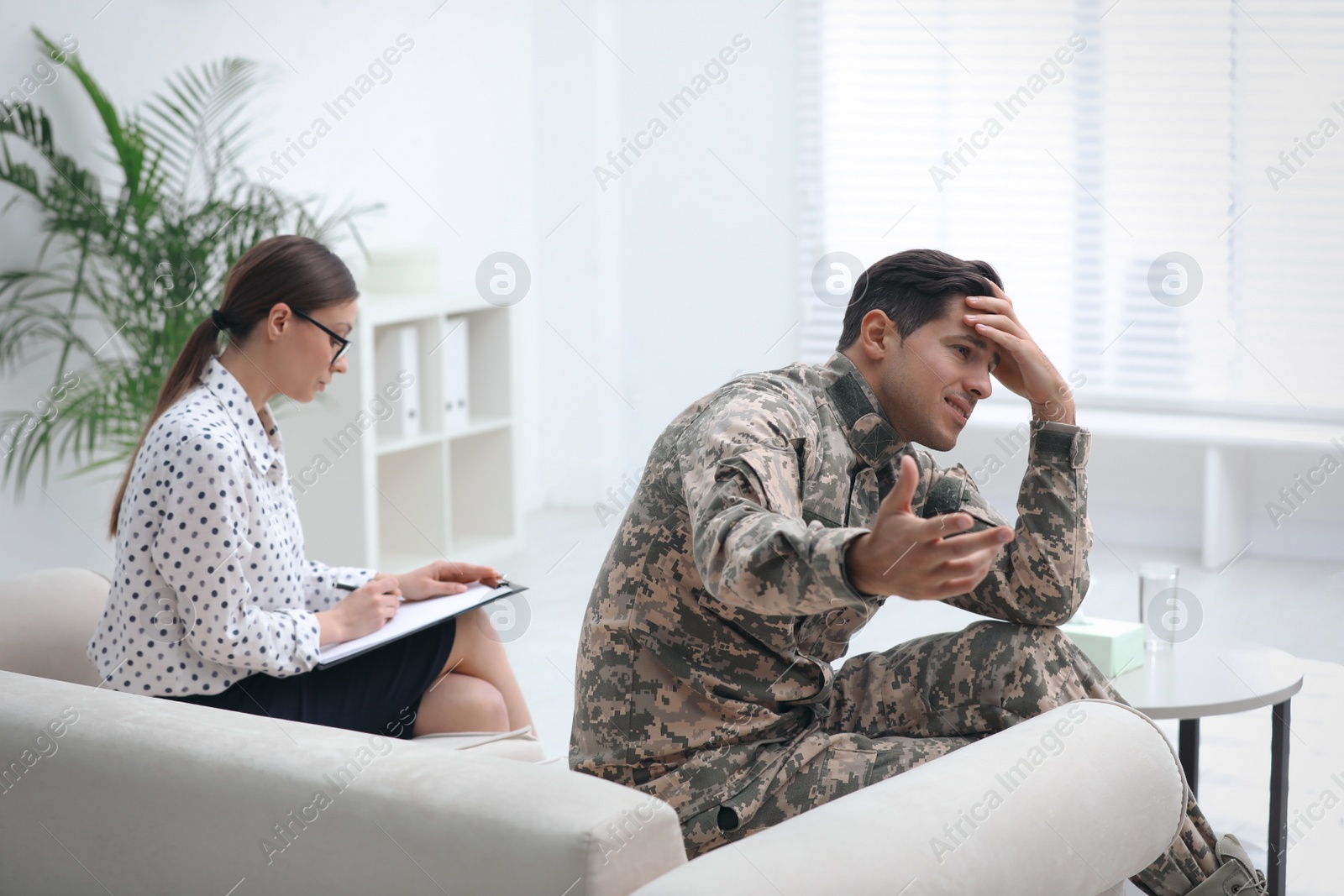 Photo of Psychotherapist working with male military officer in office