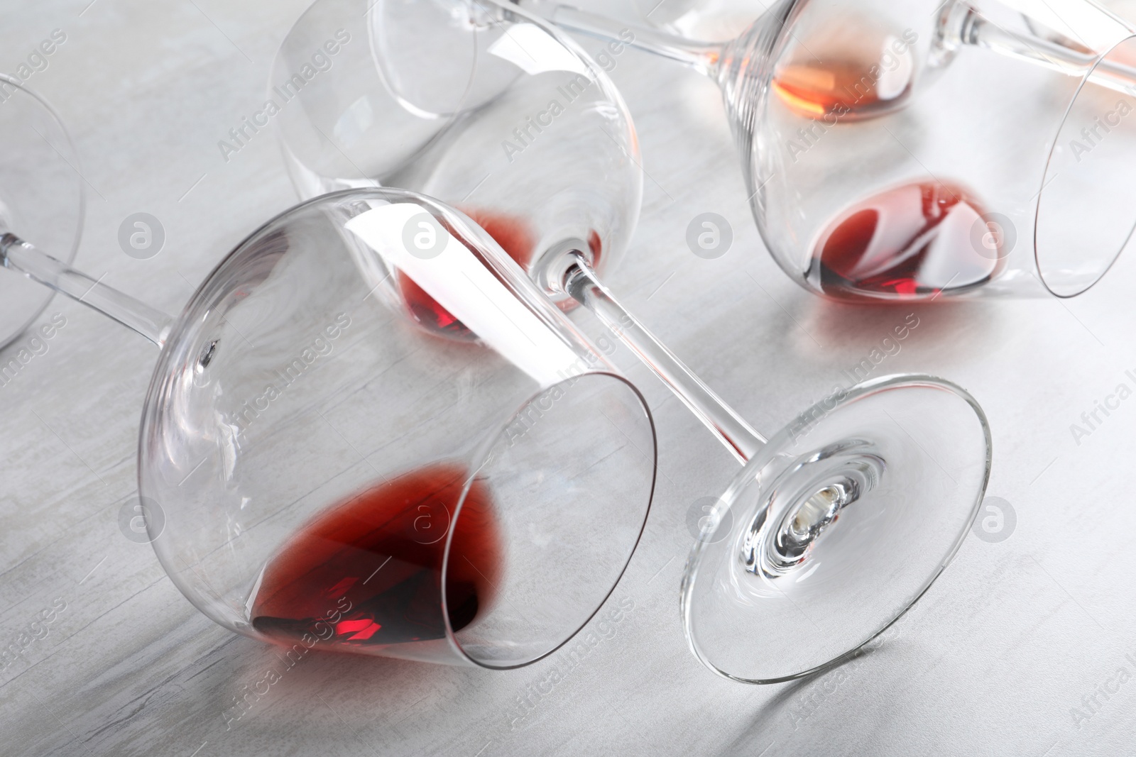 Photo of Different glasses with wine on light background, closeup