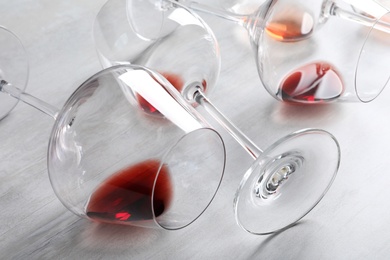 Photo of Different glasses with wine on light background, closeup