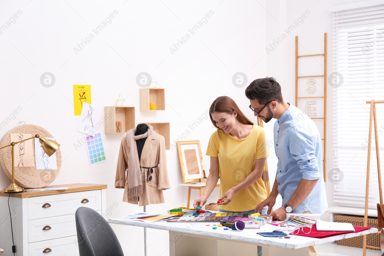 Photo of Fashion designers creating new clothes in studio