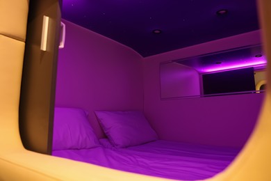 Capsule with twin bed in modern pod hostel. Stylish interior