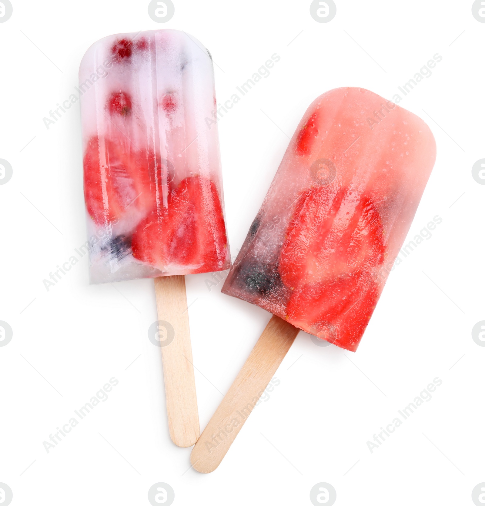 Photo of Tasty berry popsicles on white background, top view