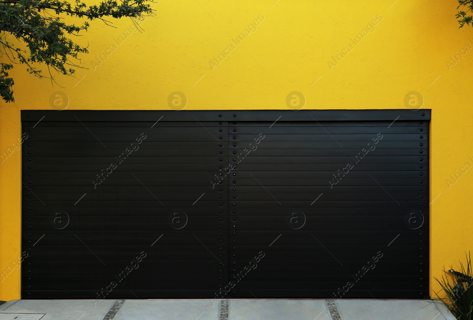 Photo of Closed gates of modern garage. Exterior design