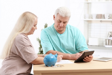 Photo of Mature couple thinking over pension payment at home