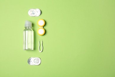 Flat lay composition with contact lenses and accessories on color background