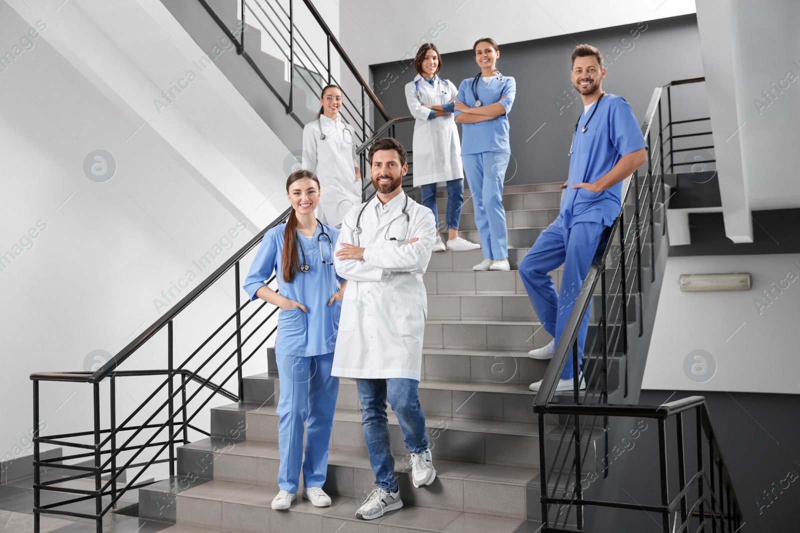 Photo of Medical students wearing uniforms on staircase in college