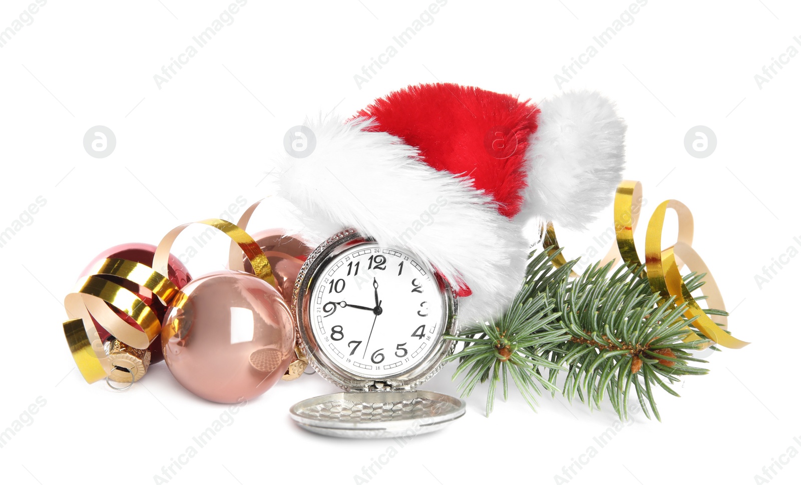 Photo of Pocket watch with Santa hat and festive decor on white background. New Year countdown