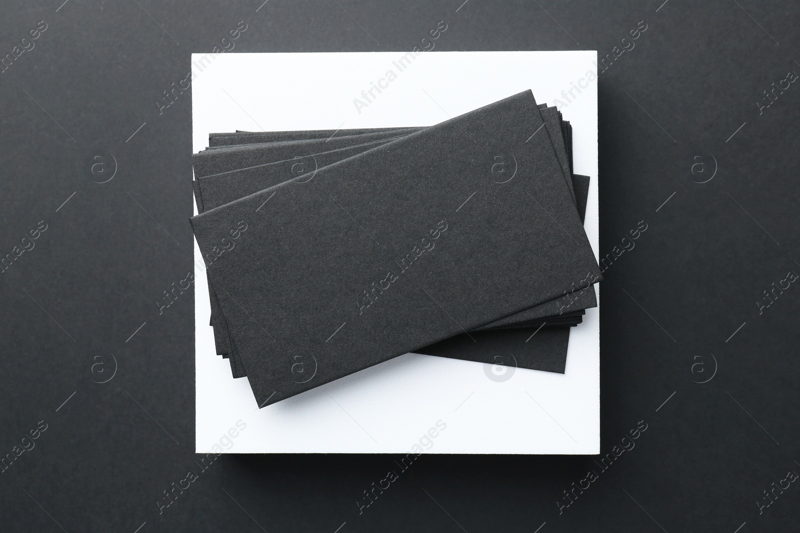 Photo of Blank business cards on black background, top view. Mockup for design