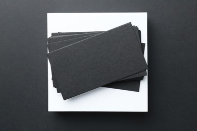 Blank business cards on black background, top view. Mockup for design