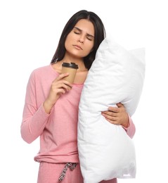 Tired young woman with soft pillow and cup of coffee on white background