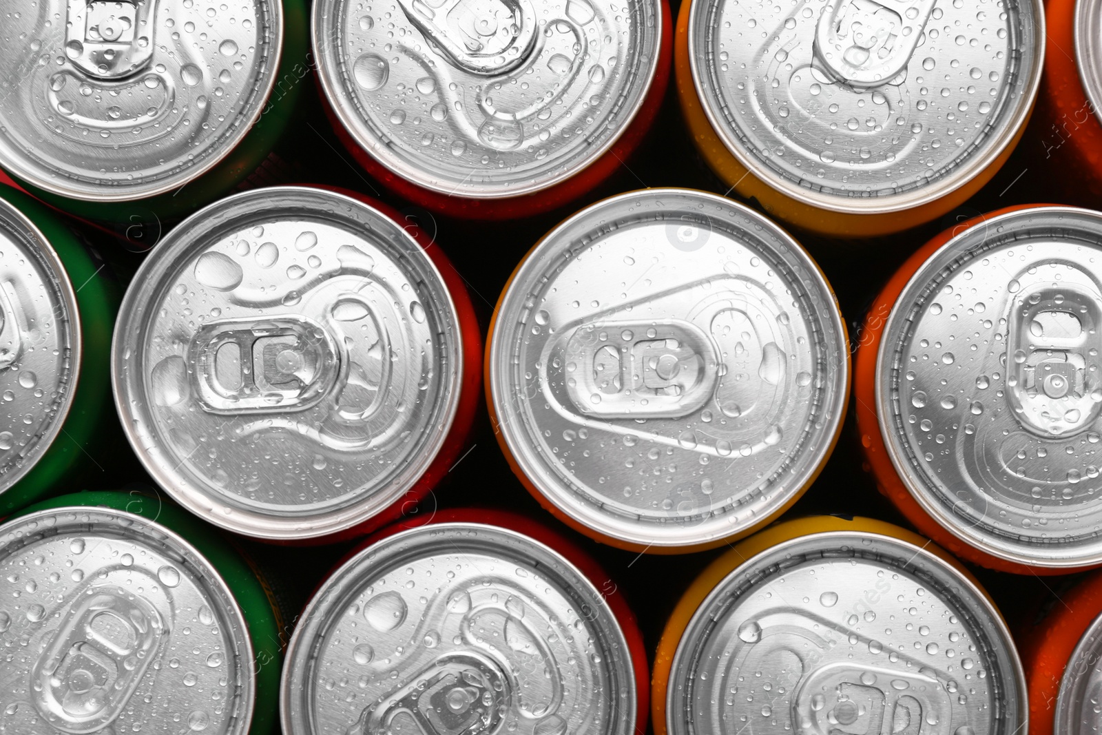 Photo of Energy drinks in wet cans, top view. Functional beverage