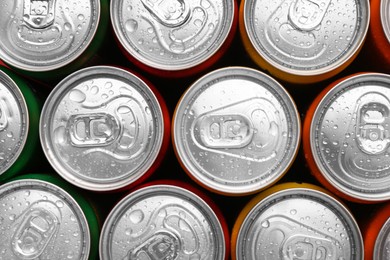 Photo of Energy drinks in wet cans, top view. Functional beverage