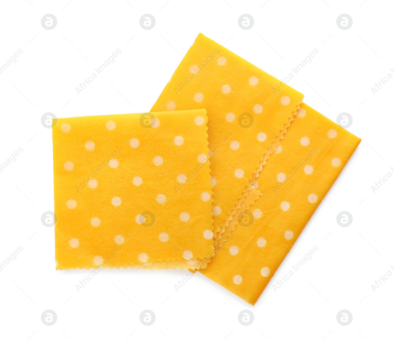 Photo of Yellow reusable beeswax food wraps on white background, top view