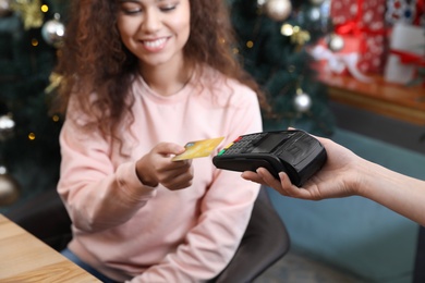 Photo of Client using credit card machine for non cash payment in cafe