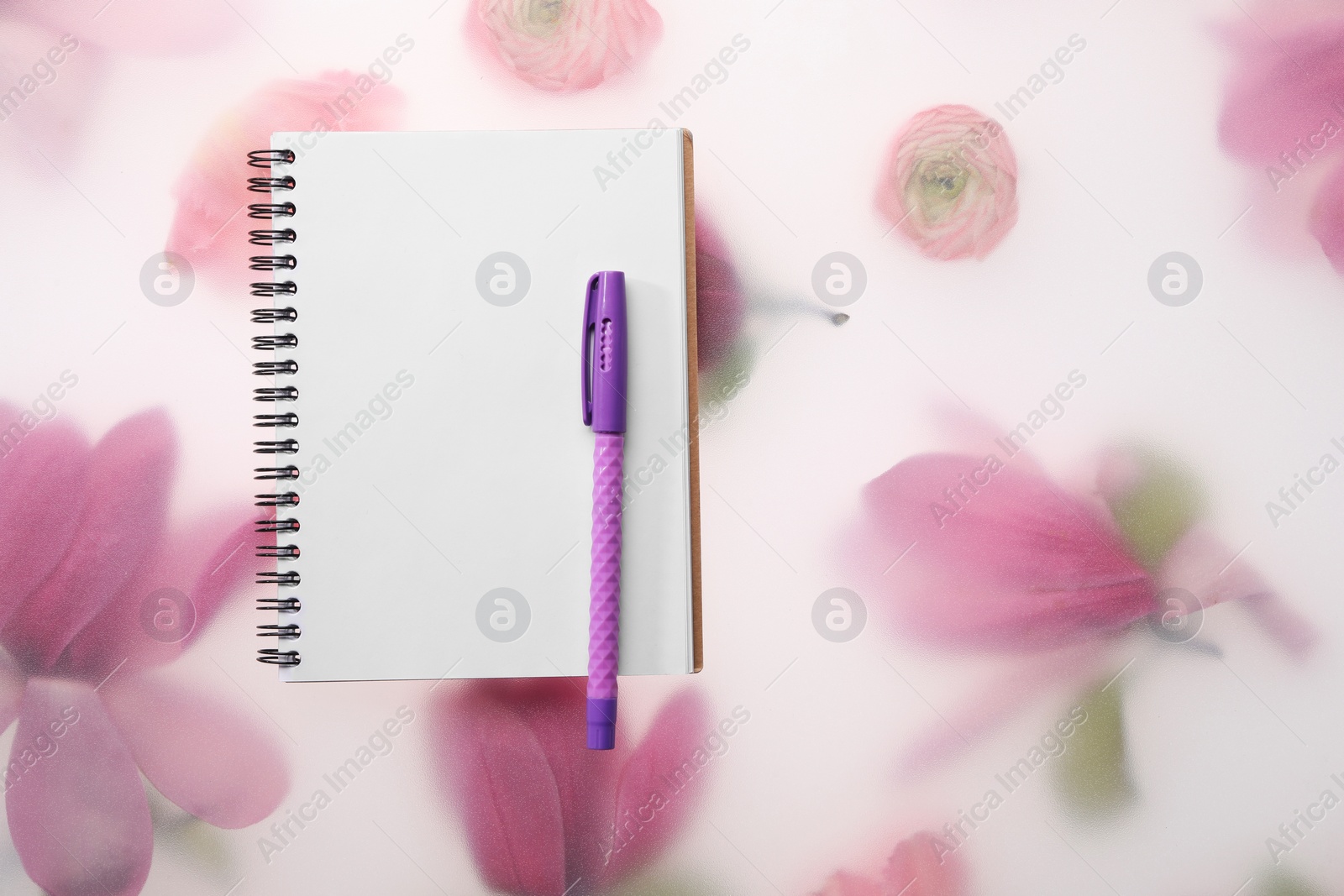 Photo of Guest list. Notebook and pen on spring floral background, flat lay. Space for text