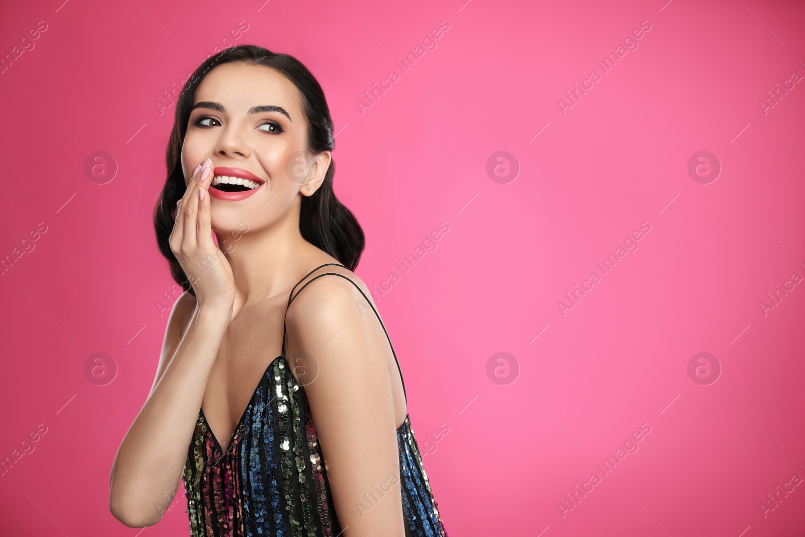 Photo of Portrait of surprised woman on pink background, space for text