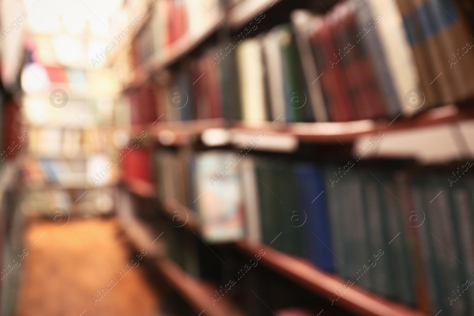 Photo of Blurred view of books on shelves in library