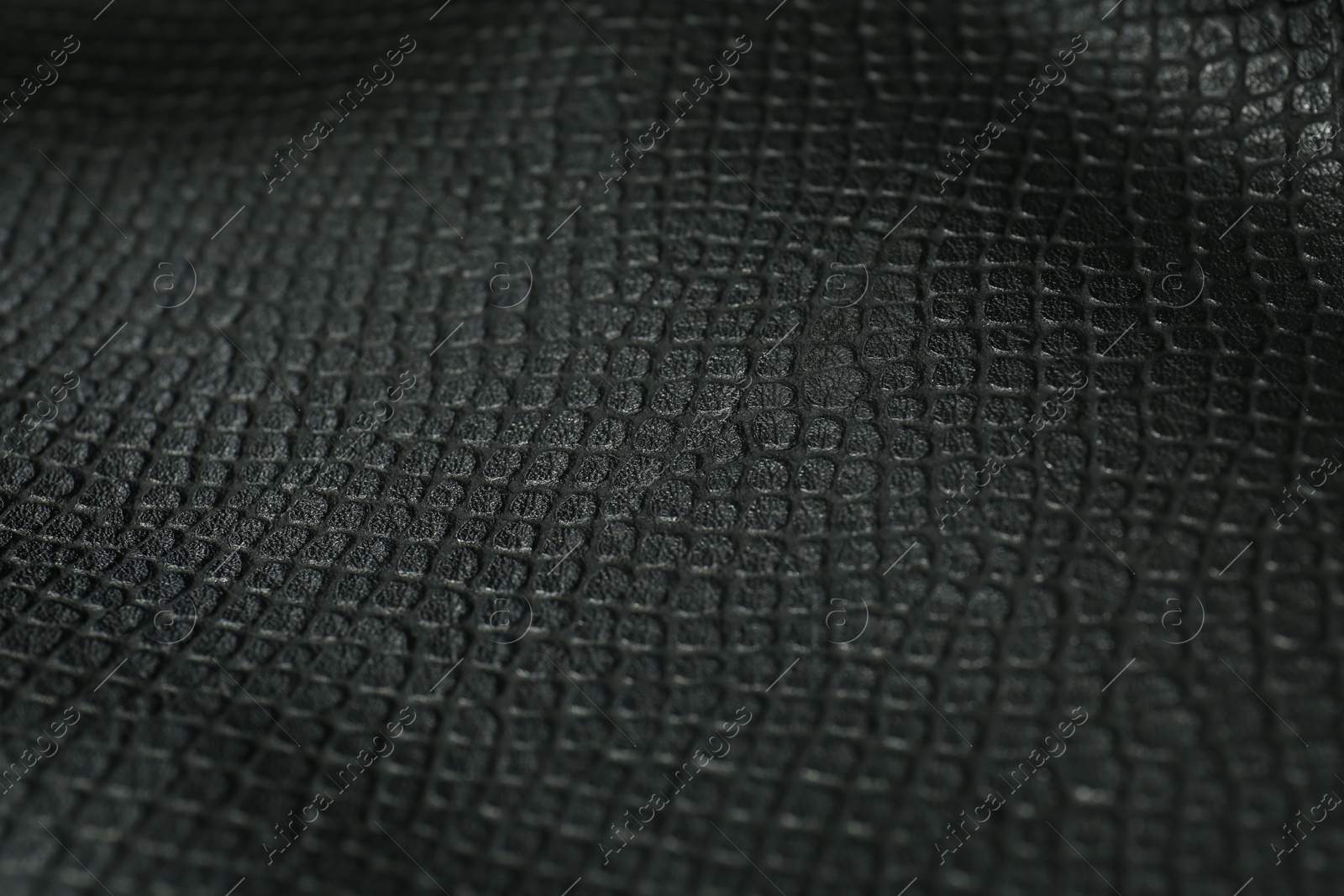 Photo of Black natural leather as background, closeup view