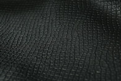 Black natural leather as background, closeup view