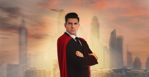 Image of Man wearing superhero cape against beautiful cityscape at sunset. Banner design