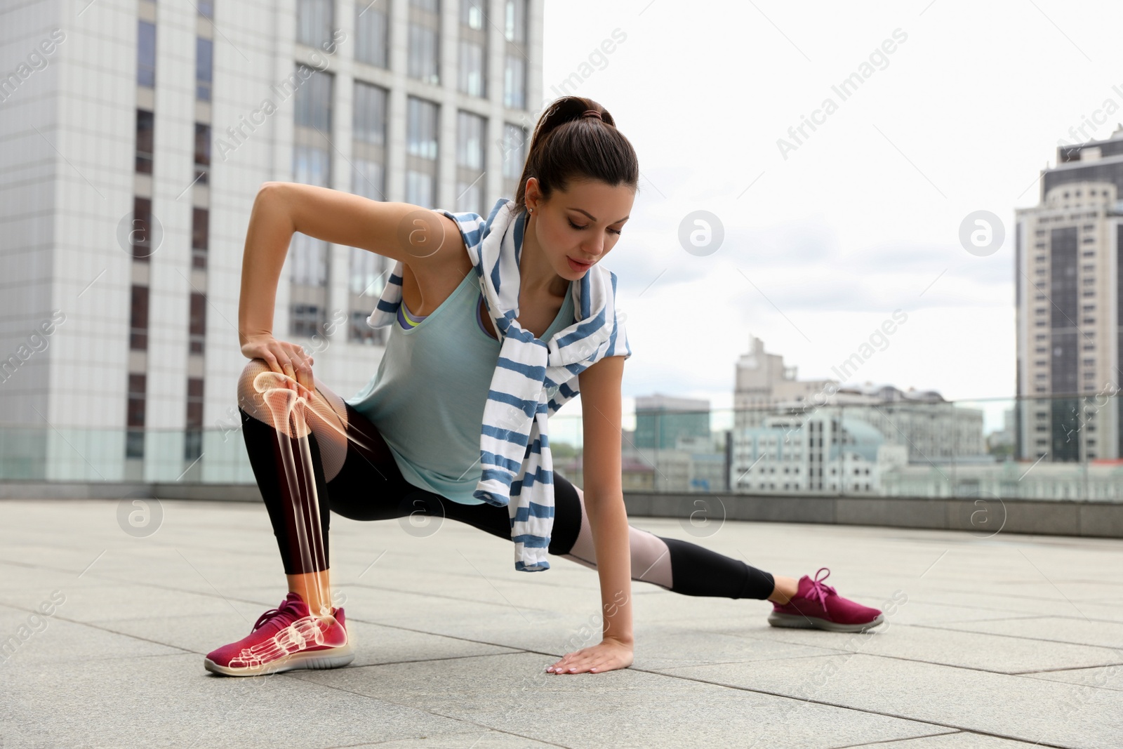 Image of Digital composite of highlighted bones and woman doing fitness exercise outdoors