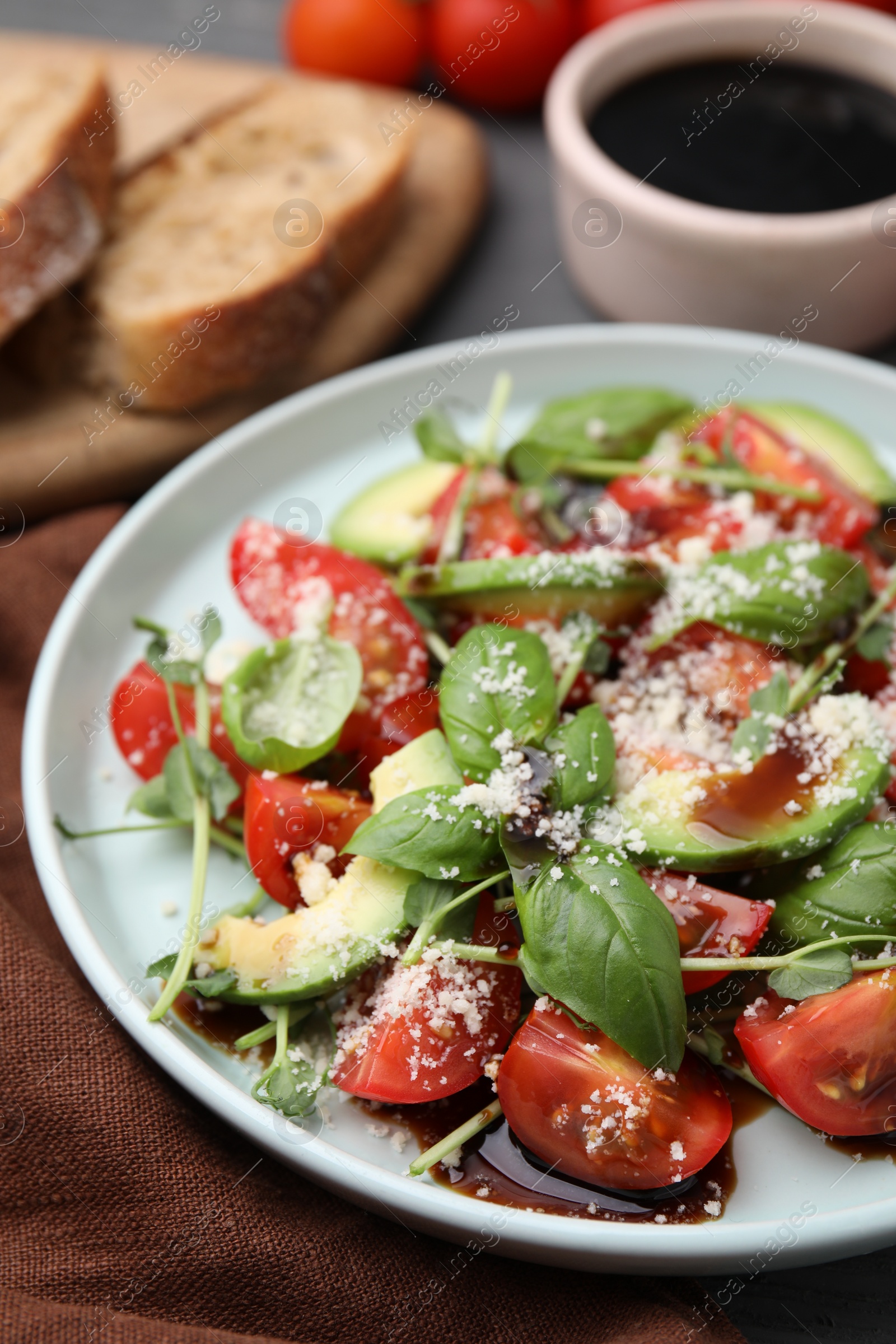 Photo of Tasty salad with balsamic vinegar on table, closeup