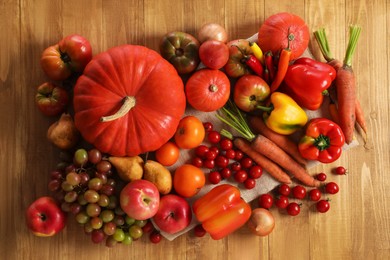 Photo of Different fresh ripe vegetables and fruits on wooden table, flat lay