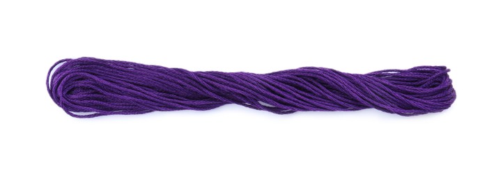 Photo of Bright purple embroidery thread on white background