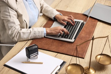 Notary using laptop at workplace in office, closeup