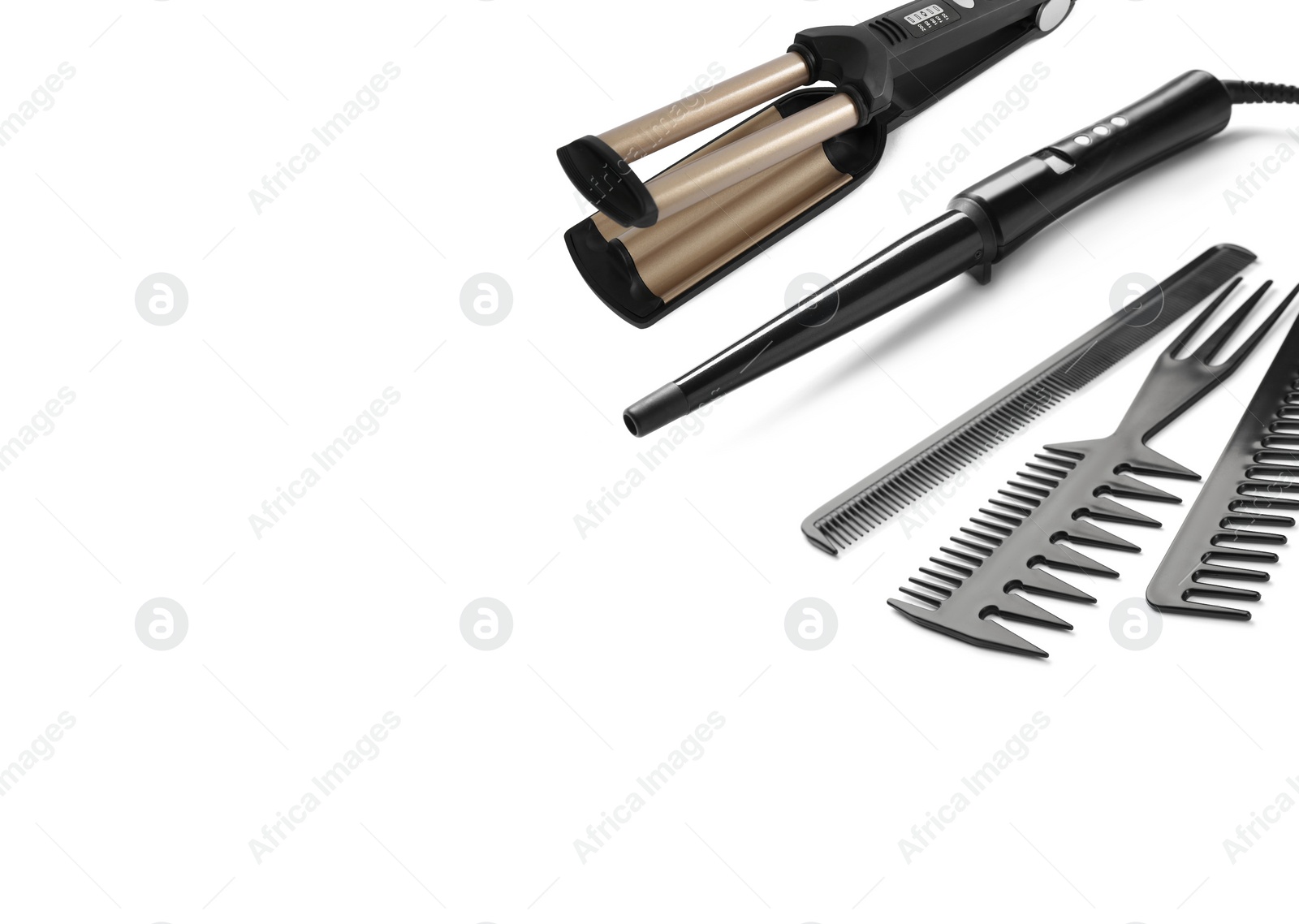 Image of Curling irons and combs on white background