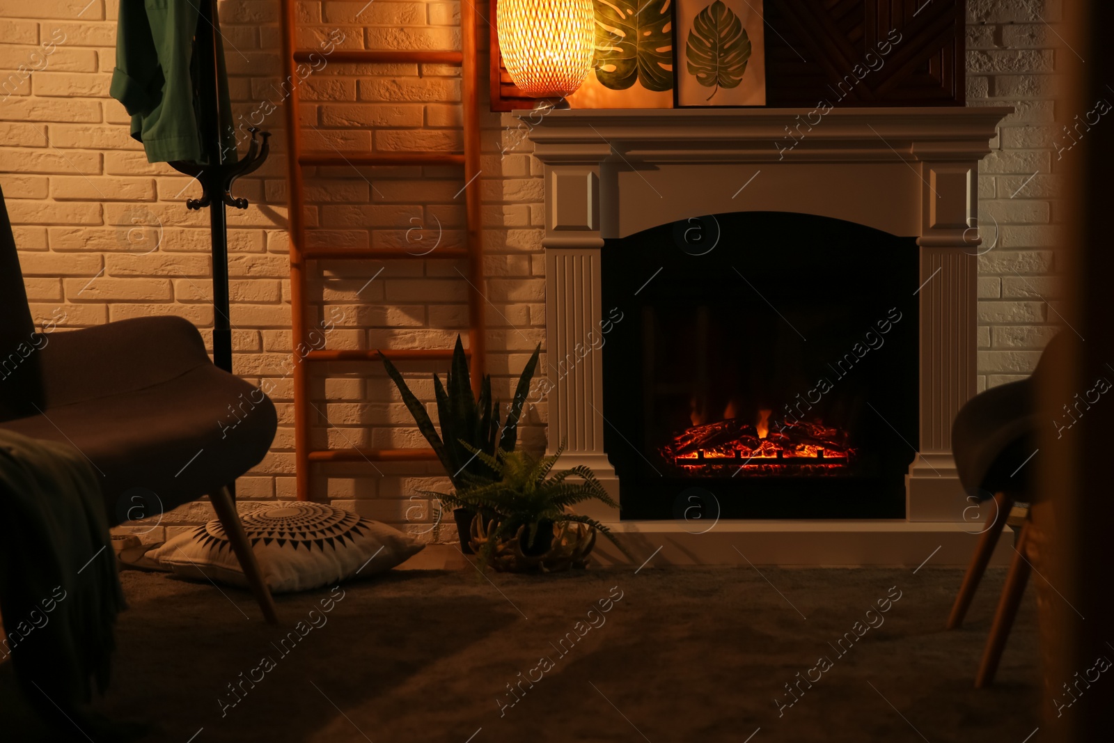 Photo of Living room interior with decorative fireplace near white brick wall