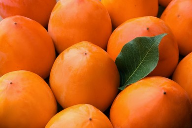 Photo of Pile of delicious ripe juicy persimmons as background, closeup