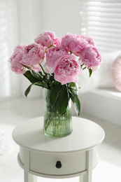 Photo of Bouquet of beautiful peonies on table indoors