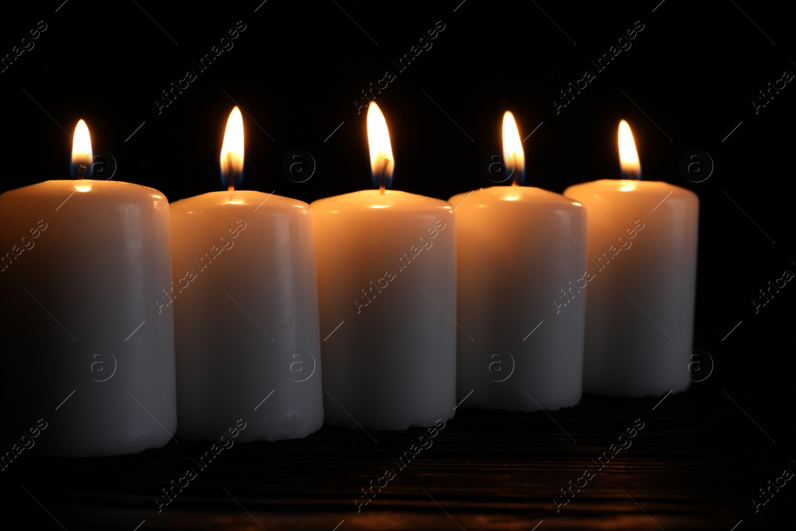 Photo of Many burning candles on table. Memory day