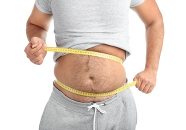 Photo of Overweight man with measuring tape on white background, closeup