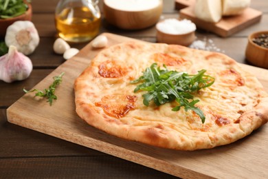Delicious khachapuri with cheese on wooden table