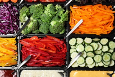 Photo of Salad bar with different fresh ingredients as background, top view