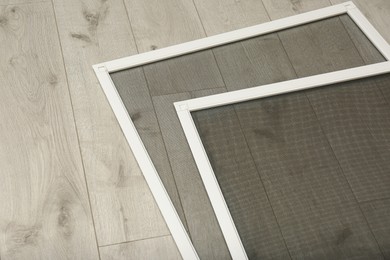 New insect screens for windows on wooden floor