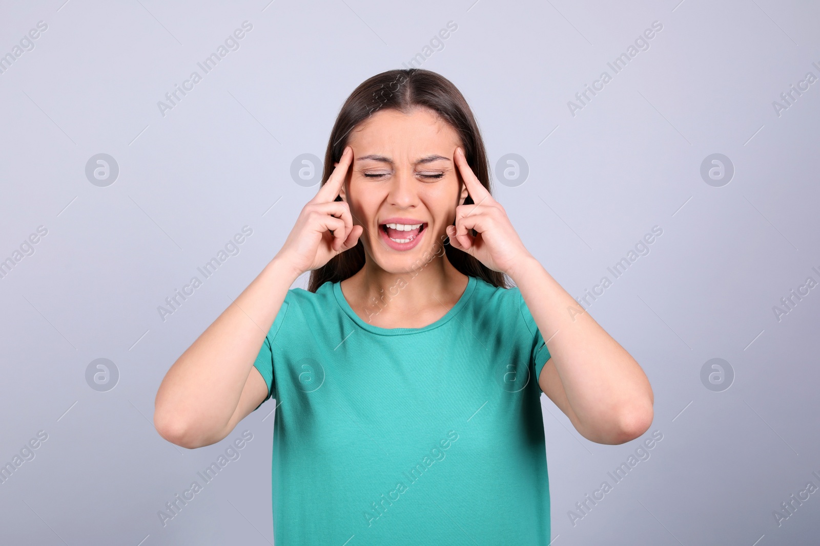 Photo of Portrait of stressed young woman on light background