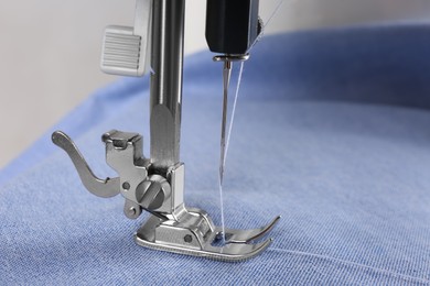 Closeup view of sewing machine with fabric