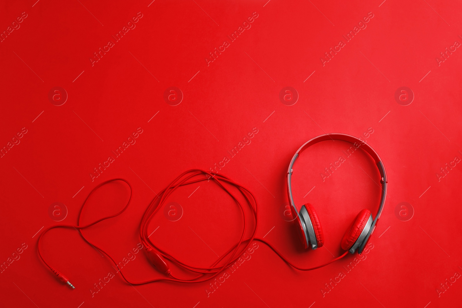 Photo of Stylish headphones on color background, top view. Space for text