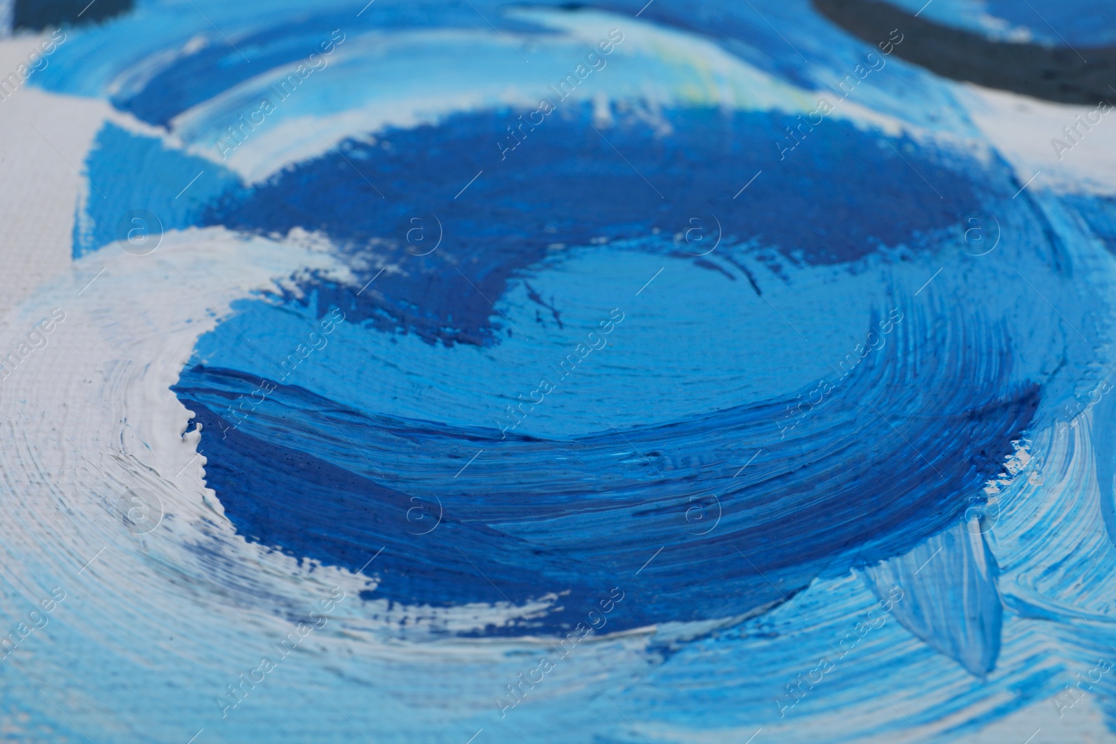 Photo of Beautiful strokes of blue oil paints on white canvas as background, closeup
