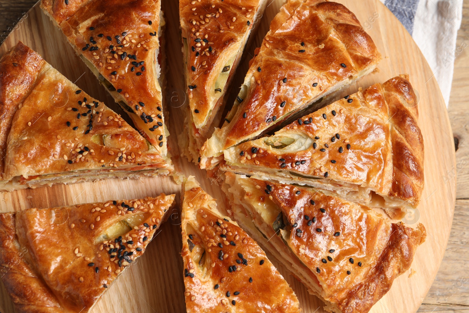 Photo of Cut delicious homemade pie on wooden table, top view