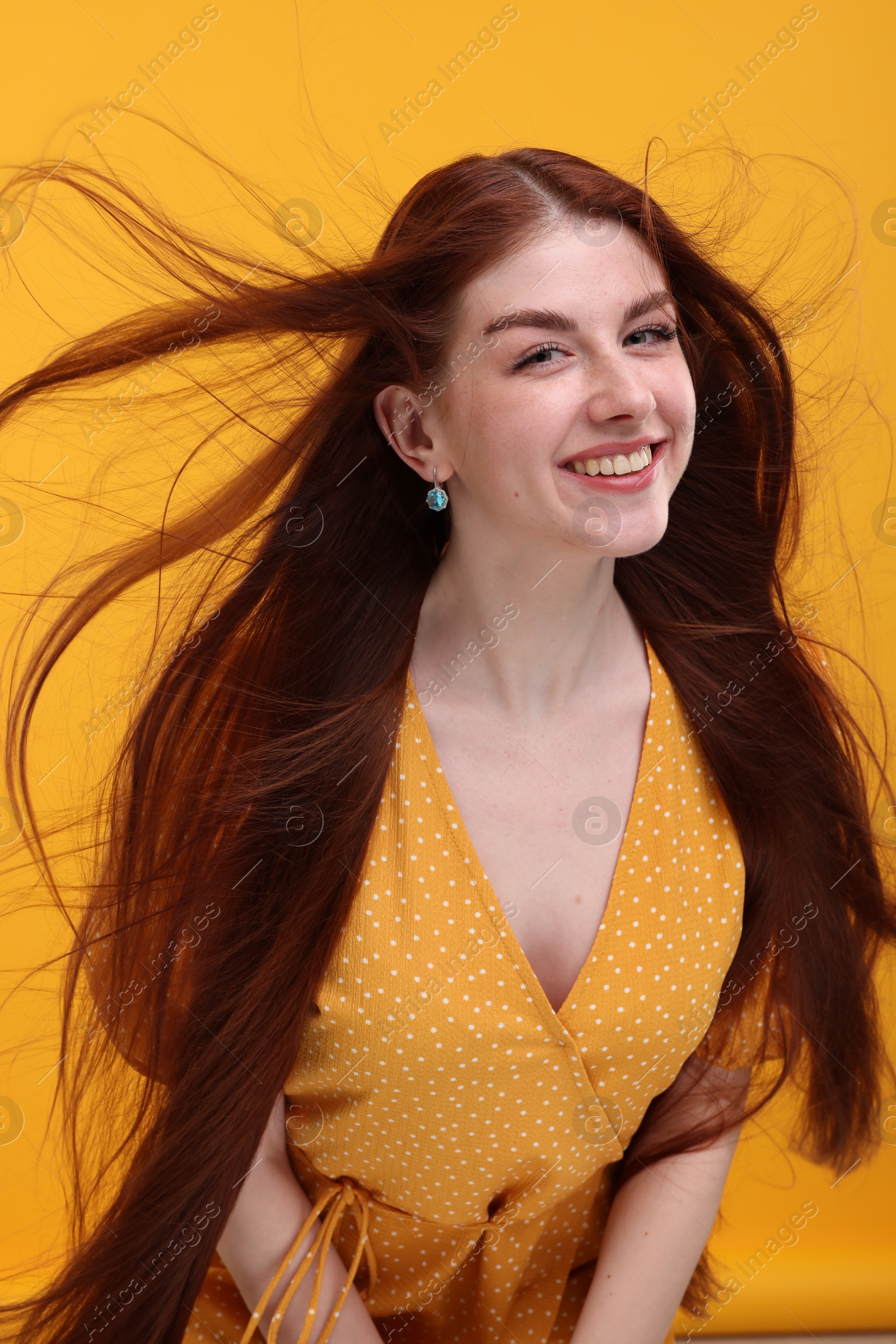 Photo of Portrait of smiling woman on yellow background