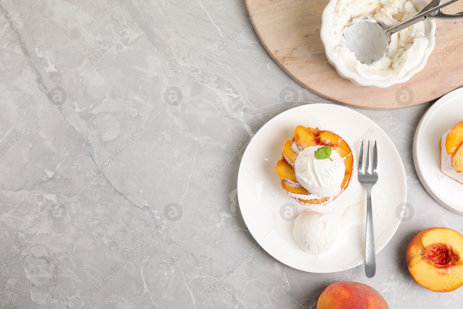 Photo of Delicious peach dessert with ice cream on light marble table, flat lay. Space for text